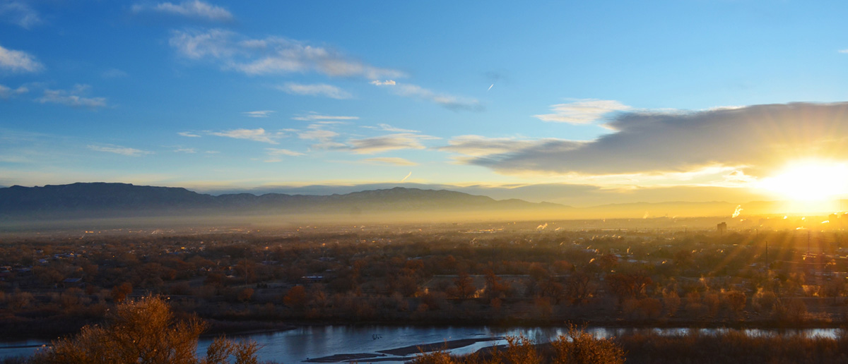 Landscape picture of a sunset over a southwestern American city